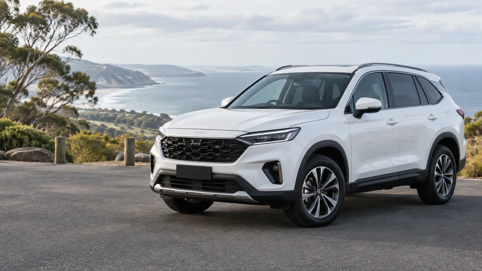 A white SUV parked at a coastal lookout